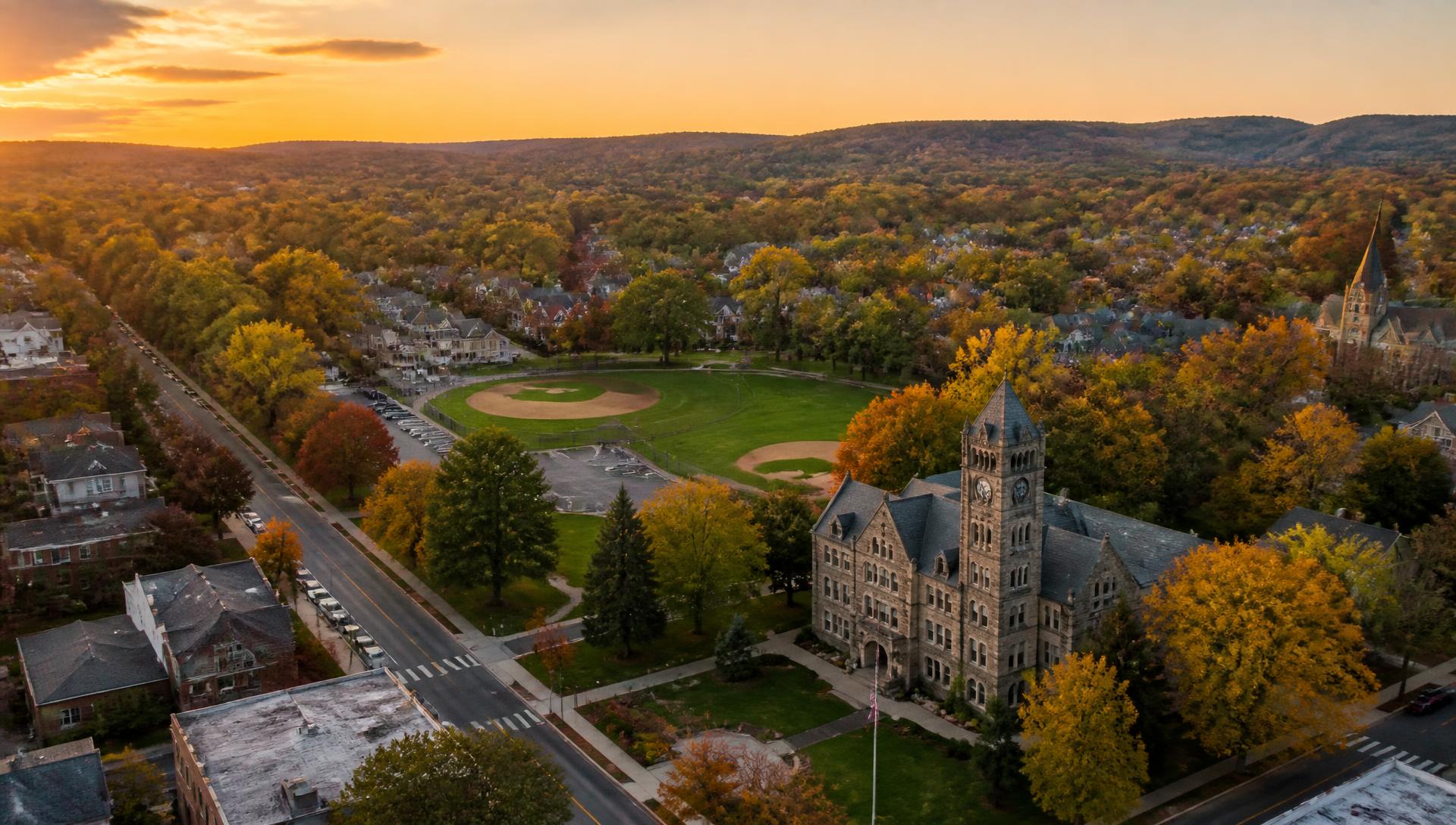 Aerial view of Marple Township at sunset with tree-lined streets and the township building